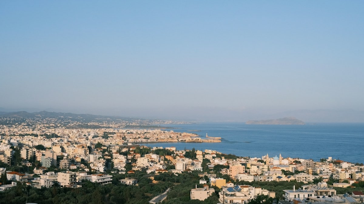 a view of a city with a body of water in the background